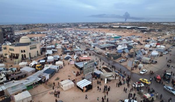 An aerial picture shows displaced Palestinians who fled Khan Yunis setting up a camp near the Gaza Strip's border with Egypt on Dec. 7, 2023. 