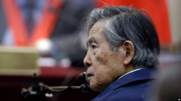 FILE - Peru's former President Alberto Fujimori listens to a question during his testimony in a courtroom at a military ba<em></em>se in Callao, Peru, March 15, 2018.