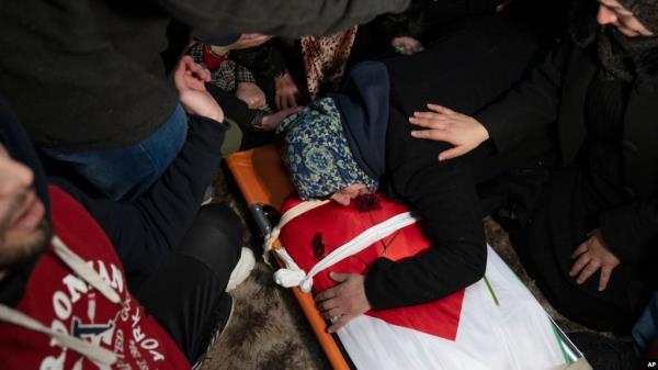 Hanan Issa Khdour, mother of Mohammad Khdour, 17, cries over the body of her son at the family house during his funeral in the West Bank village of Biddu, on Feb. 12, 2024. Khdour, a U.S. citizen, was shot Saturday by what his family alleges was Israeli fire.