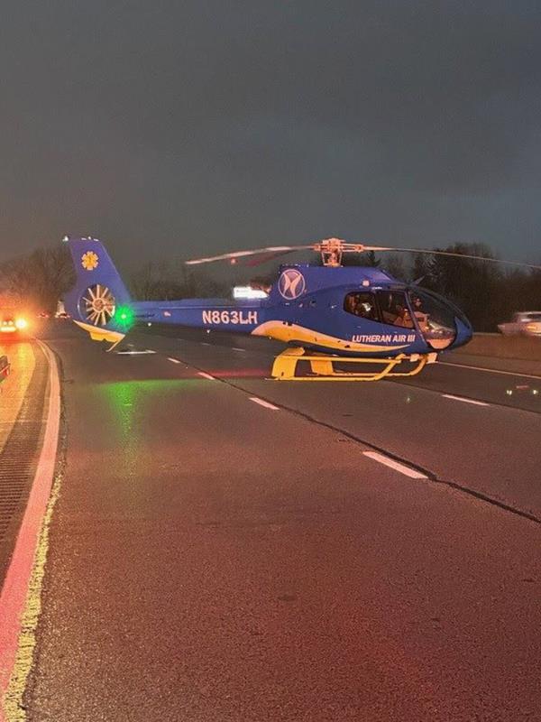 A Lutheran Air helicopter on the scene Tuesday, Dec. 26, 2023, to take a Mishawaka man to Memorial Hospital in South Bend after police say he was trapped in his pickup truck for six days after a crash on Interstate 94 at the Salt Creek overpass.- Original Credit: Indiana State Police