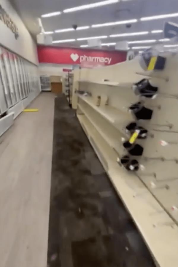 An empty row inside the CVS Pharmacy store at the Columbia Heights location can be seen. 