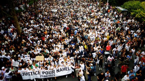 People attend a march in tribute to Nahel, a 17-year-old teenager killed by a French police officer during a traffic stop, in Nanterre, Paris suburb, France, June 29, 2023. The slogan reads 