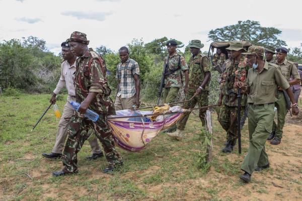 FILE - Police and local residents load the exhumed bodies of victims of a religious cult into the back of a truck in the village of Shakahola, near the coastal city of Malindi, in southern Kenya on April 23, 2023. 