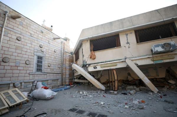 Israel levels Gaza district, missile hits Orthodox church