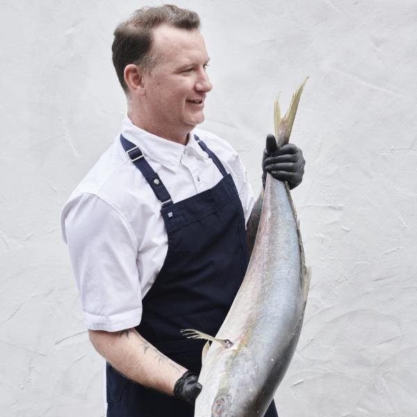 Chef Johnon Macdo<em></em>nald holding a fish.