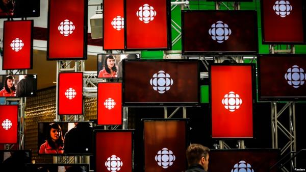 FILE - A man sits inside the Canadian Broadcasting Corp. broadcast center in Toronto, May 23, 2014.