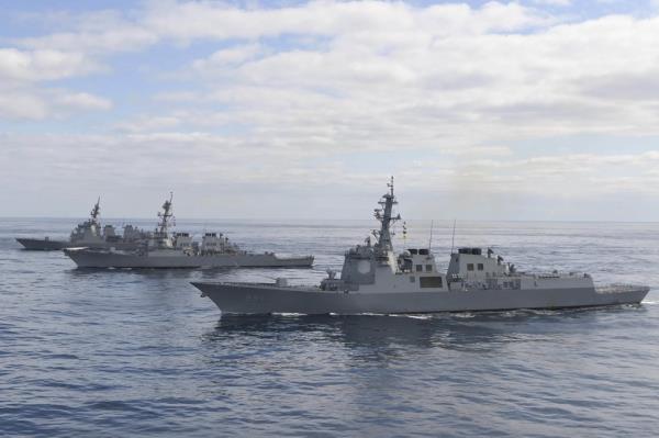 This file photo on Feb. 22, 2023, shows South Korea's ROKS Sejong the Great destroyer (front), the USS Barry destroyer (center), and Japan's JS Atago destroyer staging missile defense drills in the internatio<em></em>nal waters of the East Sea. (Joint Chiefs of Staff)