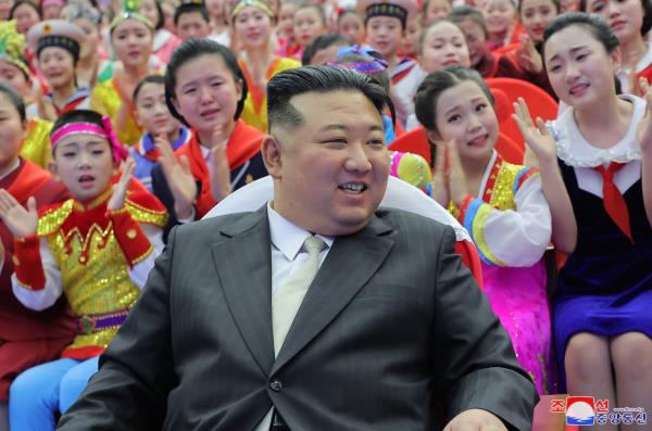 North Korean leader Kim Jong-un takes a photo with students following a New Year's Day performance at the Mangyo<em></em>ngdae Schoolchildren's Palace on Monday. (KCNA)