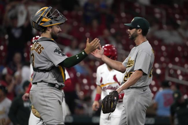 A’s catcher Shea Langeliers, left, and relief pitcher Austin Pruitt celebrate Wednesday’s win over the Cardinals in St. Louis. (Jeff Roberson / ASSOCIATED PRESS)