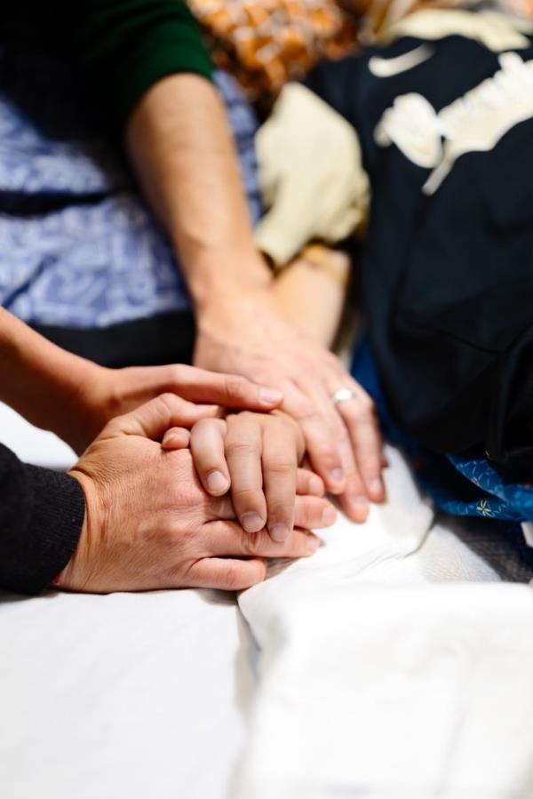 Close-up of a person's hands, symbolizing mourning and the tragic story of a 10-year-old boy from Murfreesboro, Tennessee who lost his life in a storm drain incident.