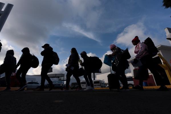 Migrants, including many Haitians, line up to enter the US via asylum appointments