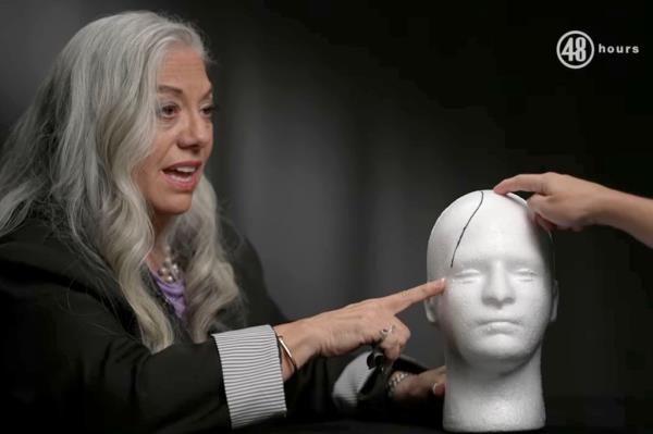 Michelle Depre drawing on a foam head. 