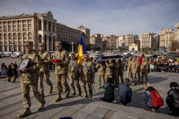 Servicemen carry the coffin of Serhiy Ikonnikov, a commander of the 72nd Mechanized Infantry Brigade and member of the European Democracy Youth Network, who was killed fighting Russian troops during the attack on Ukraine, in Independence Square in Kyiv October 19, 2023