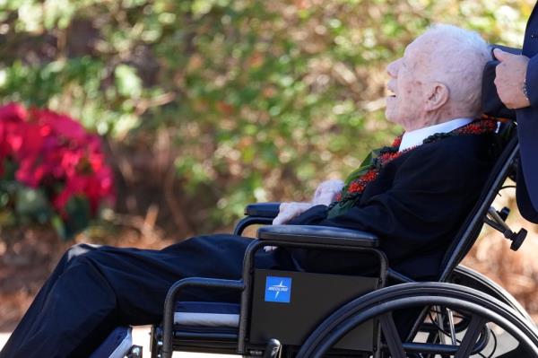 Former President Jimmy Carter departs after a during the funeral service for his wife.