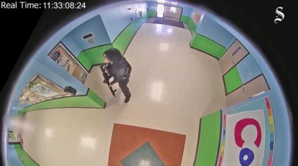 Salvador Ramos enters Robb Elementary school holding a rifle before killing 19 children and two teachers in Uvalde, Texas, U.S. May 24, 2022 in a still image from school surveillance video obtained by the Austin American-Statesman newspaper. Austin American-Statesman/Handout via REUTERS. NO RESALES. NO ARCHIVES. MANDATORY CREDIT