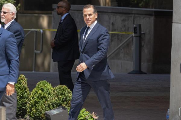 Hunter Biden walks outside in a suit