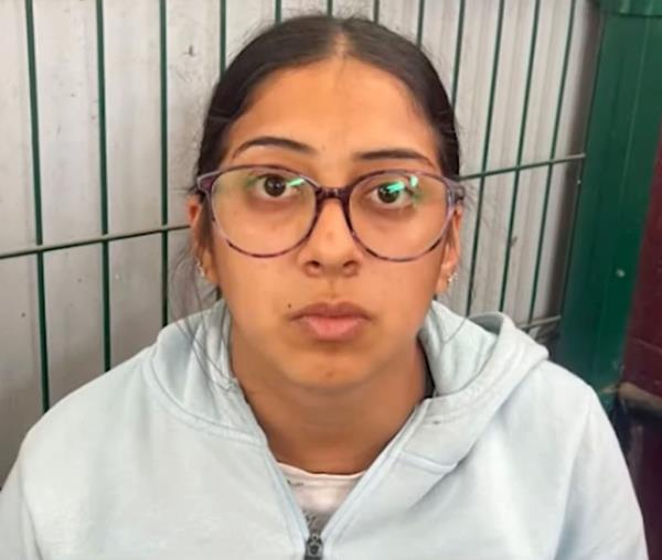 A woman wearing glasses and a sweatshirt, found with drugs and a phone co<em></em>nnected to a missing Australian surfer case, taken into custody