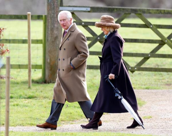 King Charles III and Queen Camilla walking on a path during Sunday service at Church of St Mary Magdalene in Sandringham.