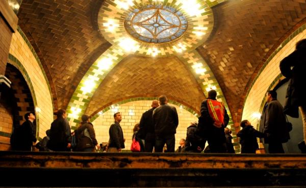 New Yorkers view the mezzanine level and stained glass skylight ceiling at the Old City Hall subway station.