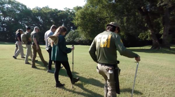 FBI agents and Georgia cops are seen combing through a property in Porterdale Thursday in search of missing Morgan Bauer's remains more than 7 years after her disappearance. 