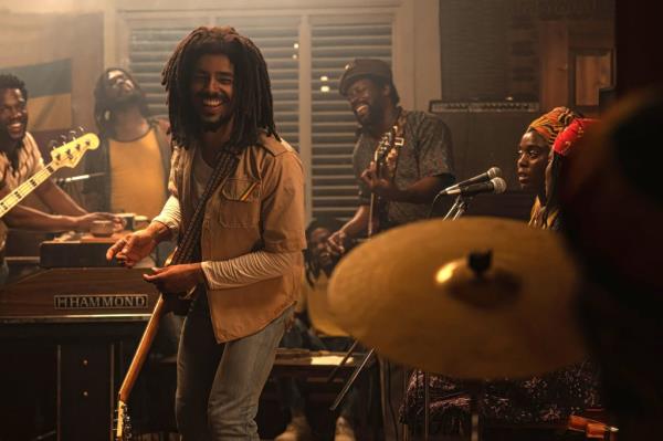 Actor Kingsley Ben-Adir is surrounded by musicians in a still from the movie 