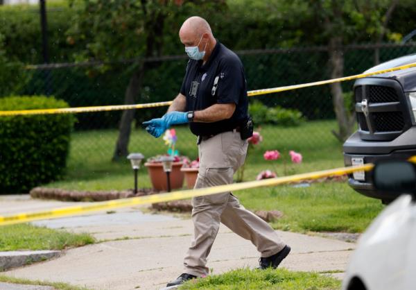 Police walk near the crime scene.