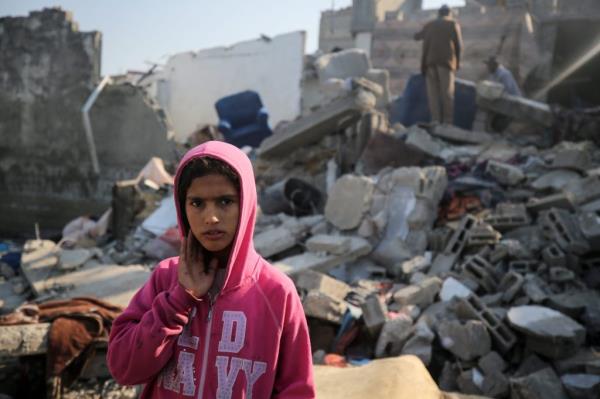 Palestinians are gathering amid the rubble of destroyed buildings following an Israeli bombardment in Deir El-Balah