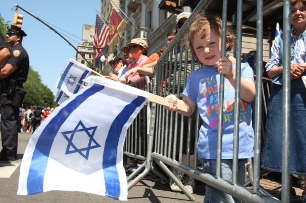 NEW YORK - MAY 31:  Malky Aschendorf, 3, of Queens, New York, waves an Israeli flag as she watches participants in the annual Salute to Israel Parade marching May 31, 2009 in New York City. Thousands marched up Fifth Avenue to celebrate the creation of the State of Israel in 1948 and also the 100th birthday of the city of Tel Aviv. 