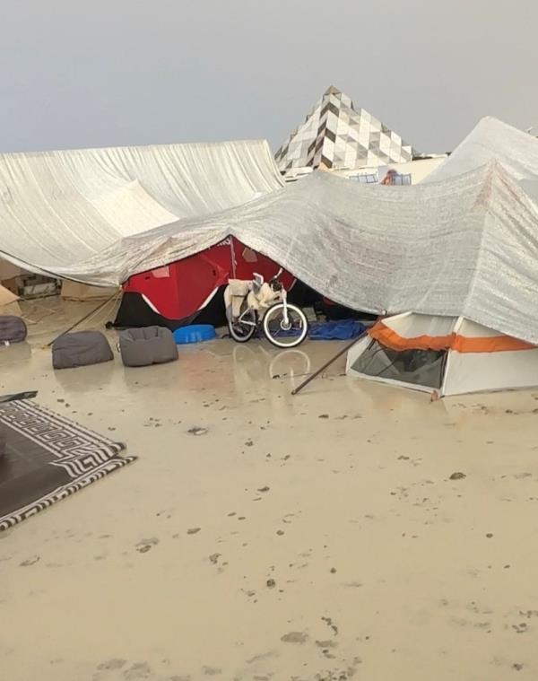 Tents are seen covered to protect them from the rain as the mud covers the ground at the site of the Burning Man festival in Black Rock, Nevada.