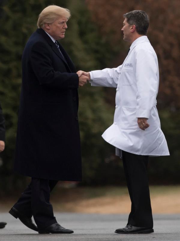 President Do<em></em>nald Trump shakes hands with then-White House Physician Rear Admiral Dr. Ro<em></em>nny Jackson, following his annual physical at Walter Reed Natio<em></em>nal Military Medical Center in Bethesda, Maryland, on January 12, 2018. 