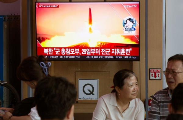 People watch a news report co<em></em>ncerning a recent North Korean missile launch, at a station in Seoul, South Korea, on Aug. 31, 2023. 