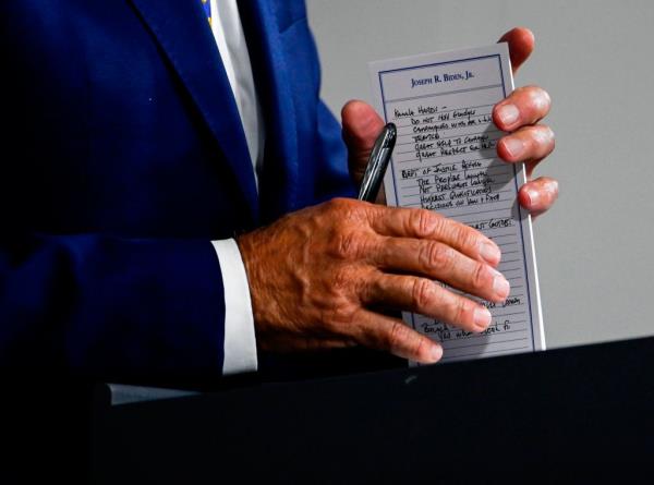 Biden holds a pad with potential Vice Presidential names on it and other notes, during a campaign event at the William 