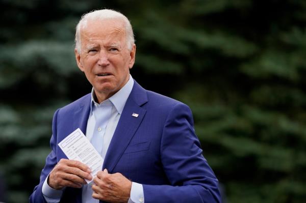 Biden places a note card in his jacket pocket during the 2020 presidential campaign 