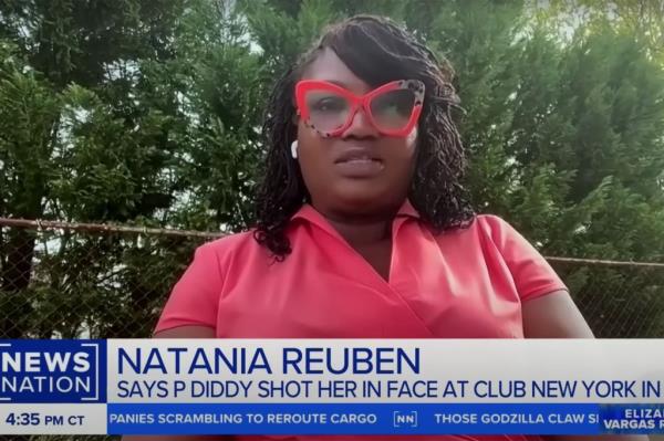 Natania Reuben wearing red glasses, seeking justice for a Club New York shooting incident in 1999 involving Sean 'Diddy' Combs