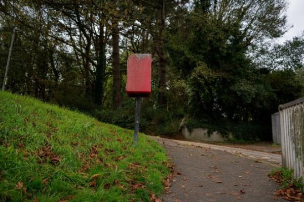 The postbox on Lynher Drive, Saltash captured on the 16th October 2023 after calls to Royal Mail have been made to move the postbox on the steep slope after a man falls while using it. See SWNS story SWLNbox. Town calls for for Royal Mail to move a postbox because it's on a 'dangerous' slope. Residents of Lynher Drive in Saltash, Cornwall, say the location is hazardous to elderly locals - after an 86-year-old man slipped and fell while using the box during heavy rainfall. Photos of the box show how it is positio<em></em>ned next to a roadside path with a steep hill bank - creating potentially hazardous co<em></em>nditions in winter. In a post on a local Facebook group, locals agreed that the box should be relocated.