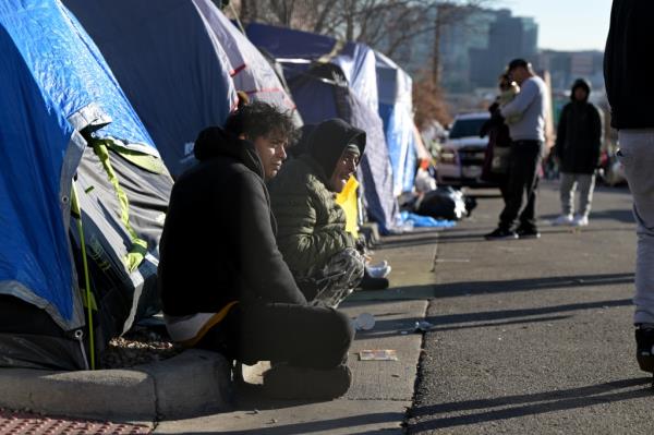 People pack and prepare to leave the largest migrant encampment on 27th Ave. between Zuni St. and Alcott St. in Denver, Colorado on Wednesday, Jan. 3.