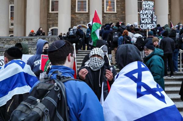 Protester wearing a keffiyeh speaks to Israel supporters during a pro-Palestine rally at Penn State University. March for Gaza.