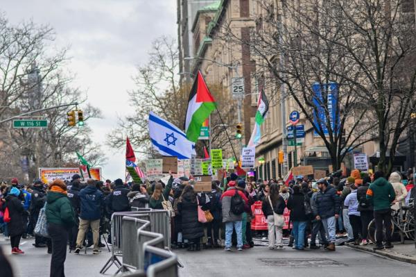 Protestors holding signs and flags in a New York City demo<em></em>nstration in solidarity with Pro-Palestinian protesters near Columbia University.