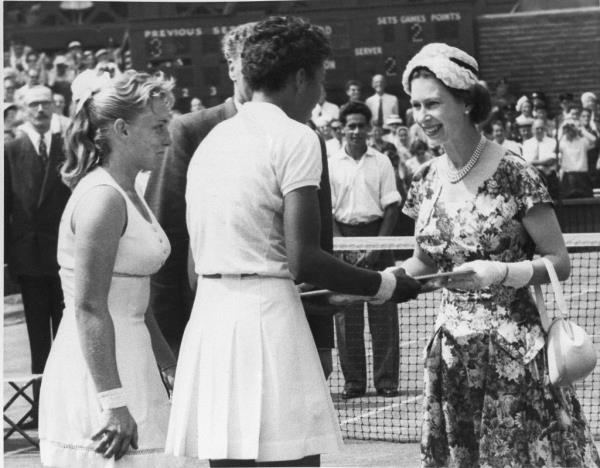 Queen Elizabeth II presents trophies to Althea and her opponent, Darlene Hard.