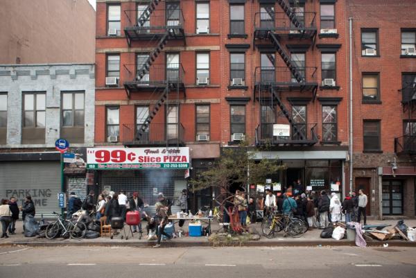 Local residents barbeque food on the street in New York City.