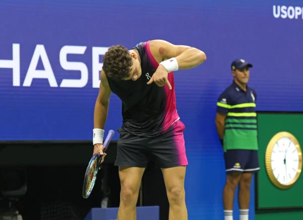 Ben Shelton clicks the phone after his quarterfinal win Tuesday night at the U.S. Open.