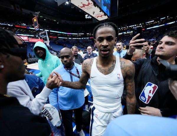 Memphis Grizzlies guard Ja Morant (12) celebrates after scoring the game-winning basket at the buzzer in a game against the New Orleans Pelicans in New Orleans on Dec. 19, 2023. 