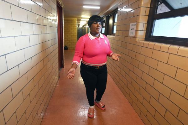 Shaquana Applewhite stands exasperated in her hallway in the Bushwick Houses.