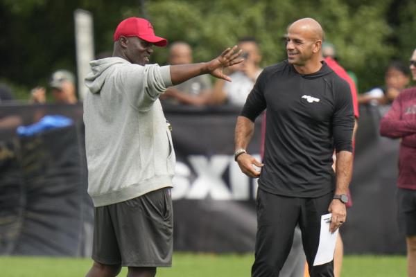 With his Bucs set to face the Jets this weekend in the preseason, head coach Todd Bowles (left) keeps pushing off a decision on naming his Week 1 starting quarterback. (AP Photo/Seth Wenig)