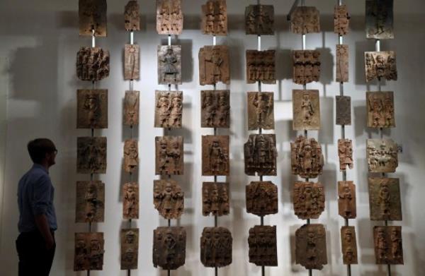 FILE PHOTO: An employee poses as he views examples of Benin bro<em></em>nzes which, together with collections such as the Parthenon sculptures, are the subject of talks of their return to countries of origin, displayed at the British Museum in London, Britain, January 25, 2023. REUTERS/Toby Melville/File Photo