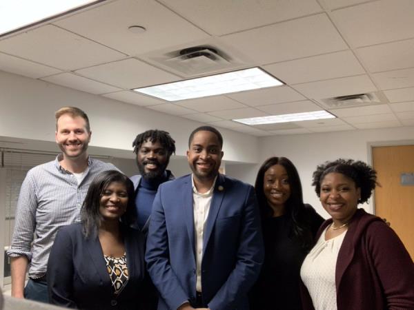 Myrie (center) poses with his staff.