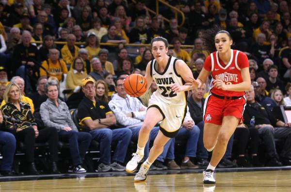 Caitlin Clark (22) dribbles down court as Ohio State's Celeste Taylor (12) defends Sunday, March 3, 2024 at Carver-Hawkeye Arena in Iowa City, Iowa.