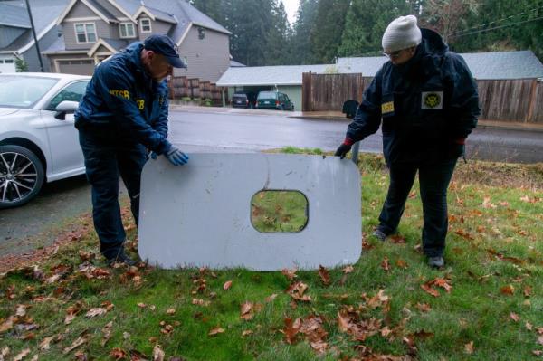 : Natio<em></em>nal Transportation Safety Board (NTSB) investigators examine the fuselage plug area of Alaska Airlines Flight 1282 Boeing 737-9 MAX, which was jettiso<em></em>ned and forced the aircraft to make an emergency landing, at a property wher<em></em>e it was recovered in Portland, Ore., on Jan. 8, 2024. 