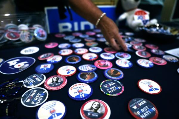 A supporter displays buttons in favor of President Joe Biden's reelection at at the Charleston County Democratic Party's Blue Jan on Saturday, Nov. 18, 2023, in Charleston, S.C.