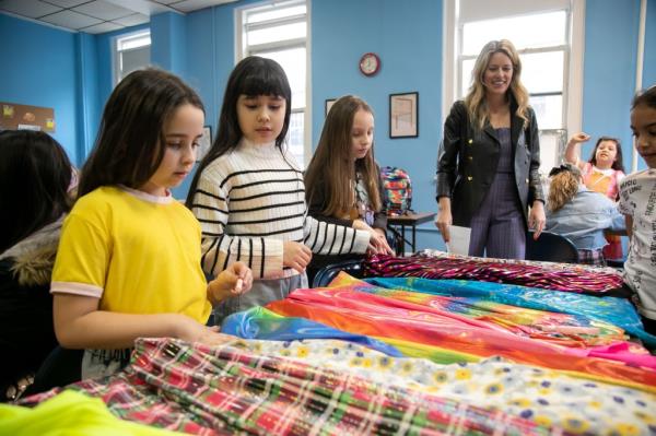 Students pick out fabric samples.